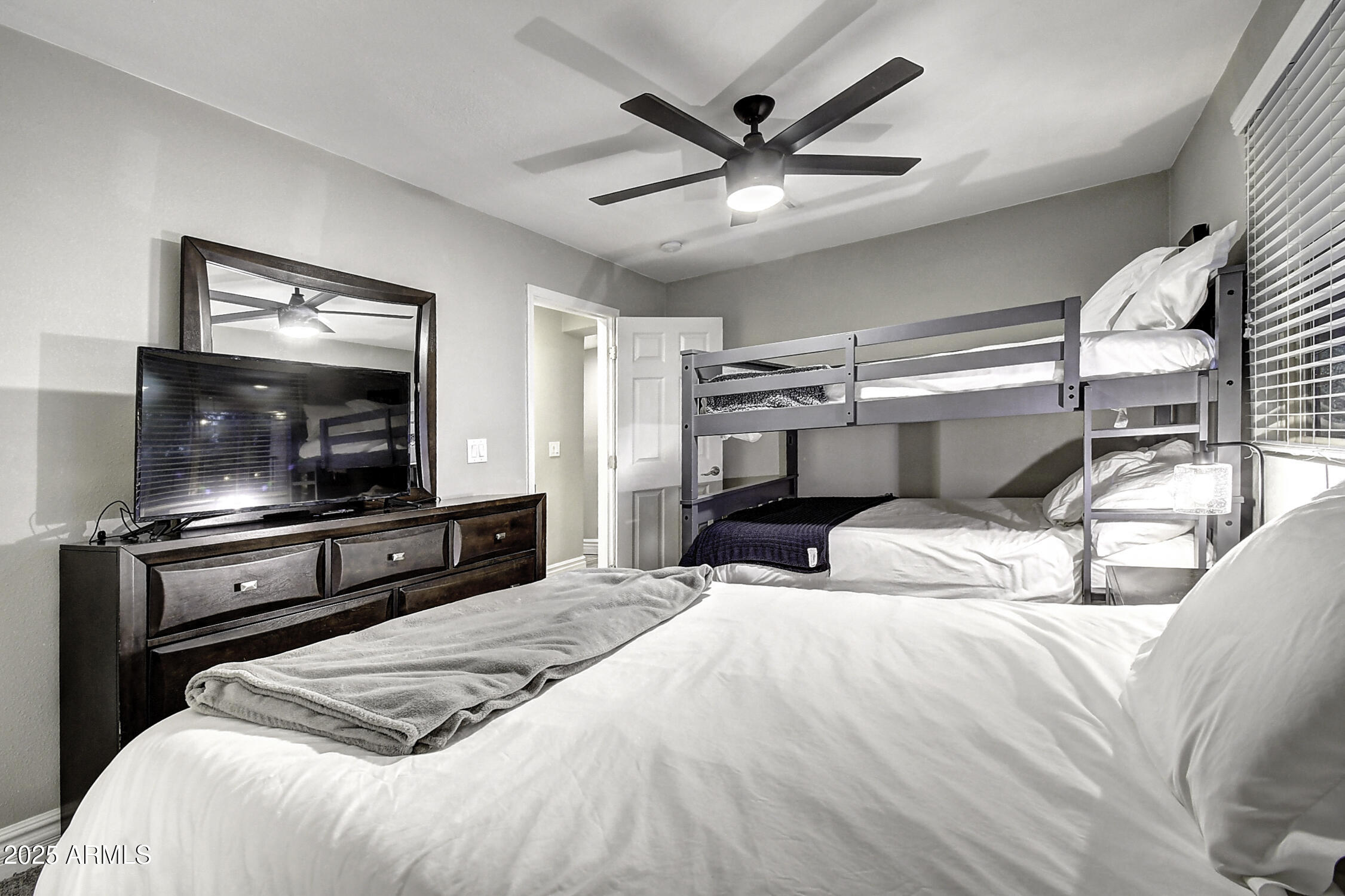 4101 East Nisbet Road Phoenix, AZ 85032 - Photo 61 of 64 a bedroom with a large bed and a flat screen tv