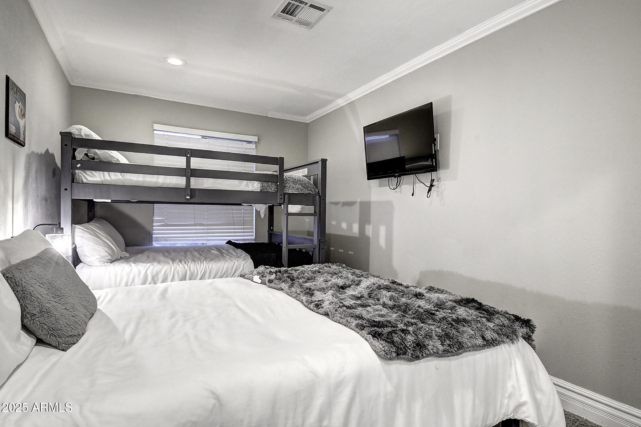 4101 East Nisbet Road Phoenix, AZ 85032 - Photo 62 of 64 a bedroom with a bed and a flat screen tv