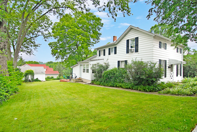 128 Howard Street Geneva, IL 60134 - Photo 1 of 29 a view of a house with a yard and sitting area