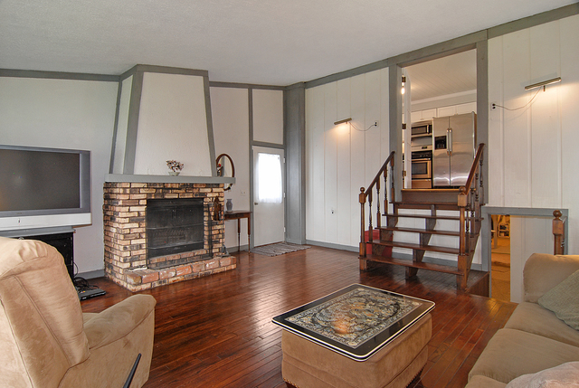 128 Howard Street Geneva, IL 60134 - Photo 2 of 29 a living room with furniture a fireplace and a flat screen tv