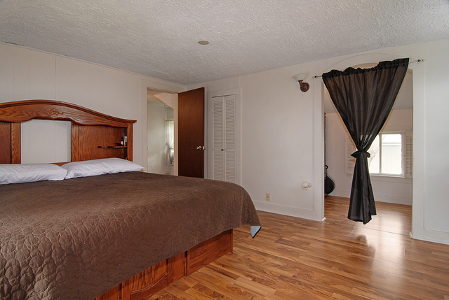128 Howard Street Geneva, IL 60134 - Photo 14 of 29 a bedroom with a bed and a painting on the wall