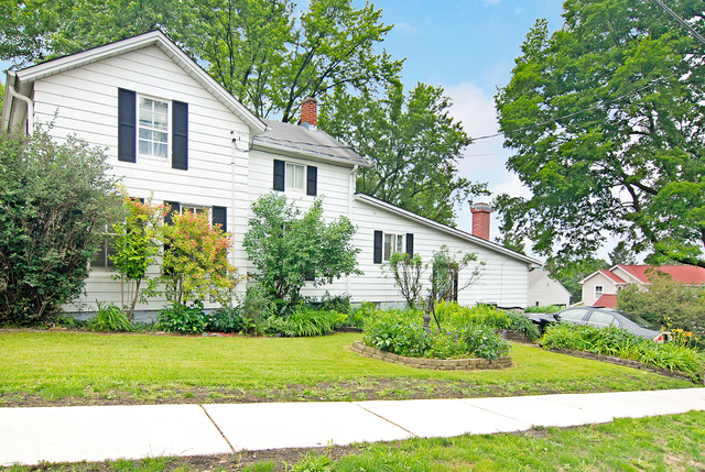 128 Howard Street Geneva, IL 60134 - Photo 23 of 29 a front view of a house with a yard