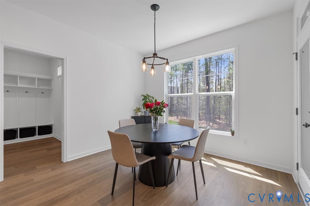 17131 Westington Road Moseley, VA 23120 - Photo 14 of 34 a dining room with furniture wooden floor and a chandelier