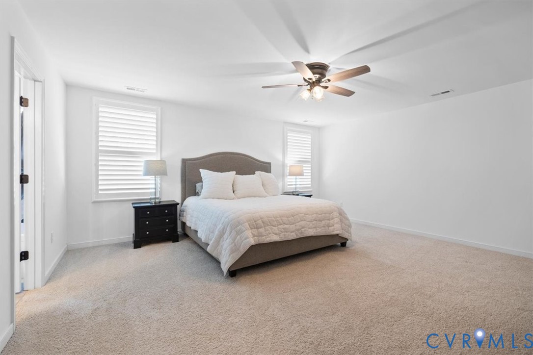 17131 Westington Road Moseley, VA 23120 - Photo 20 of 34 a bedroom with a bed and a chandelier