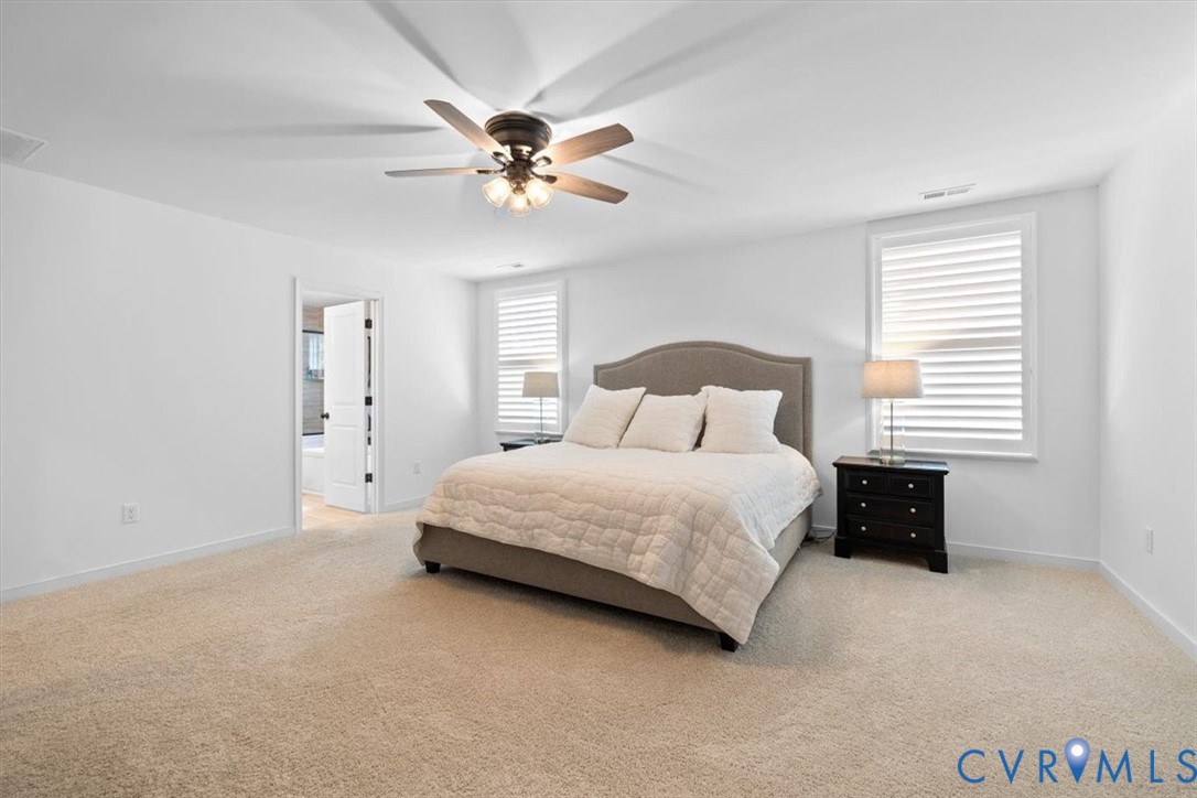 17131 Westington Road Moseley, VA 23120 - Photo 21 of 34 a bedroom with a bed and a chandelier