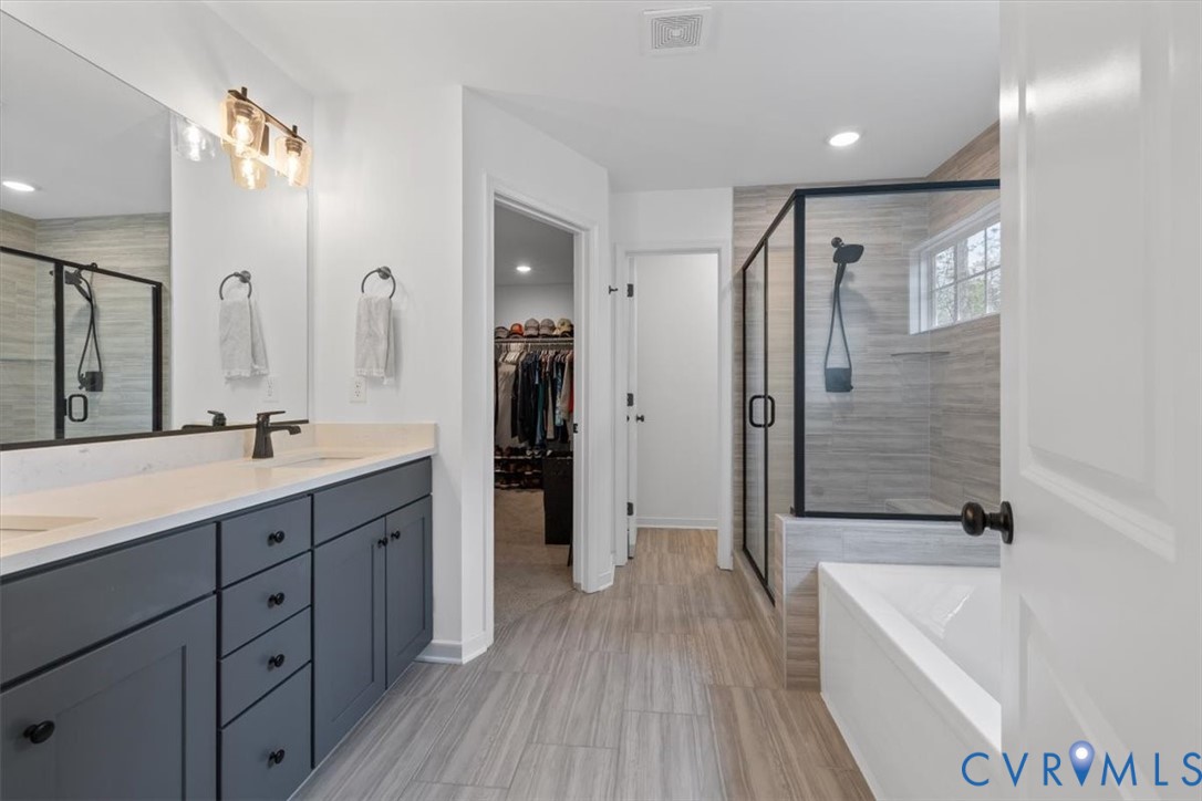 17131 Westington Road Moseley, VA 23120 - Photo 22 of 34 a spacious bathroom with a double vanity sink a mirror a shower and a bathtub