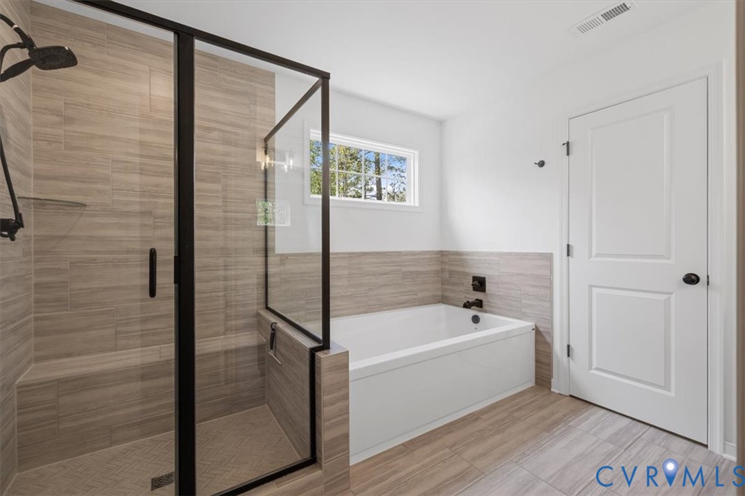 17131 Westington Road Moseley, VA 23120 - Photo 23 of 34 a bathroom with a tub and shower