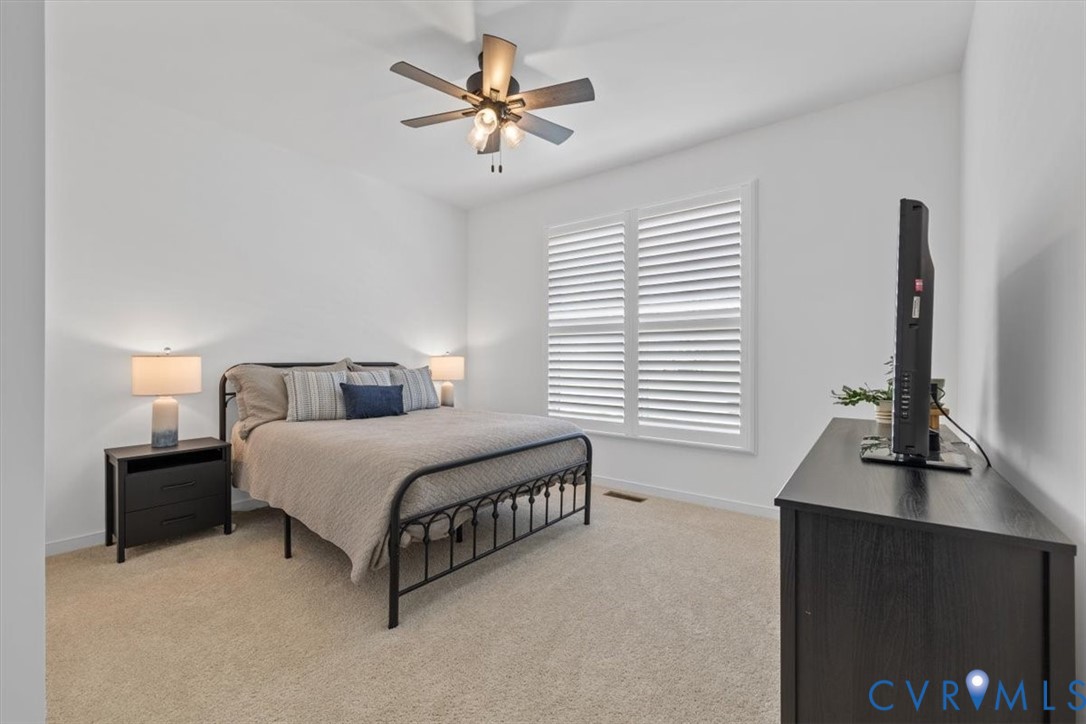 17131 Westington Road Moseley, VA 23120 - Photo 25 of 34 a spacious bedroom with a bed window and a flat screen tv