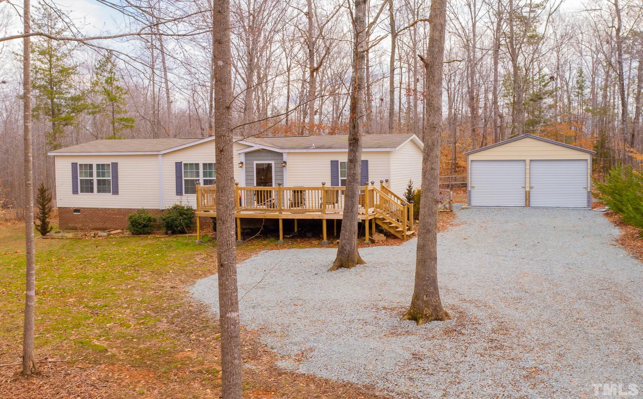 a view of a house with backyard and trees