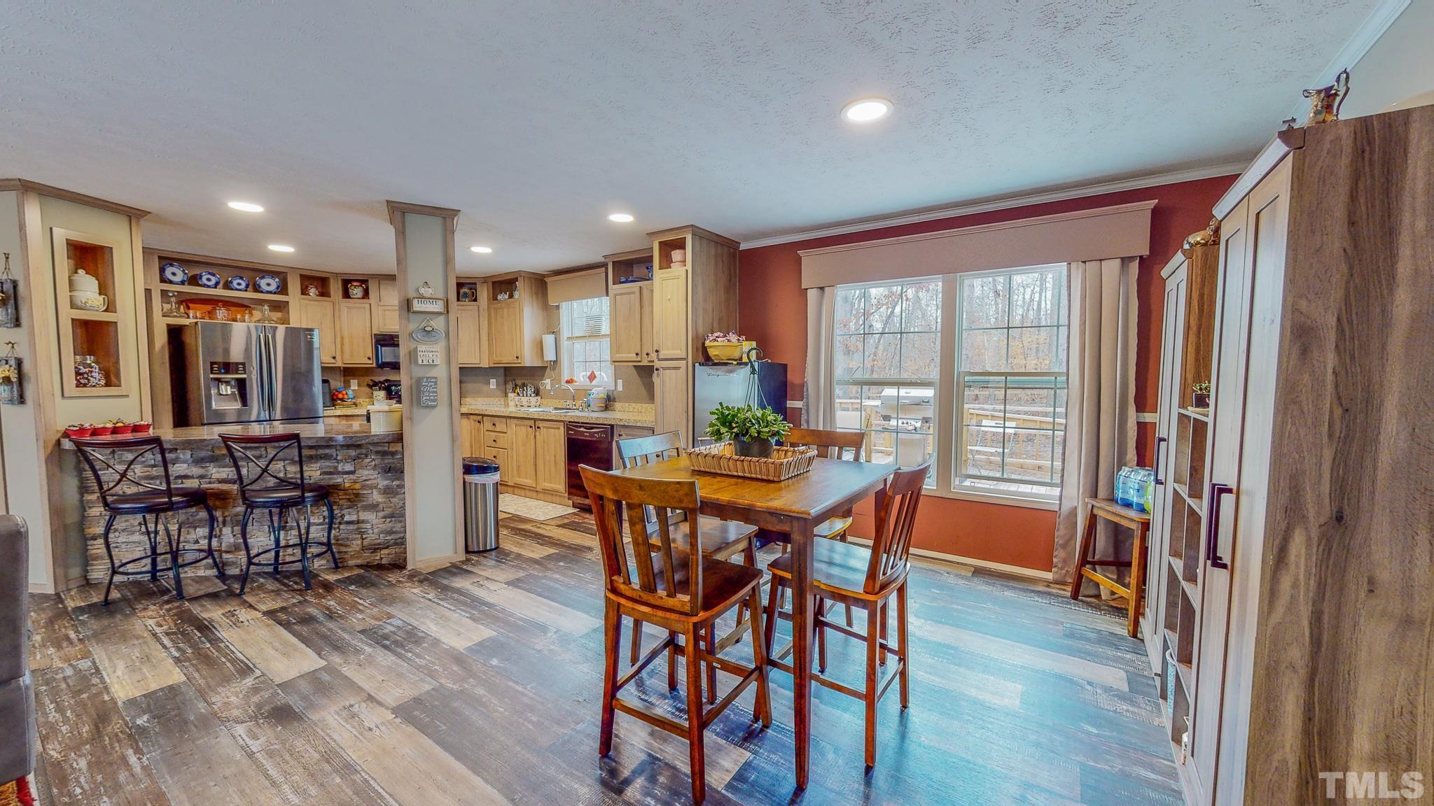 100 Marco Road Roxboro, NC 27574 - Photo 13 of 47 a view of a dining room with furniture and wooden floor