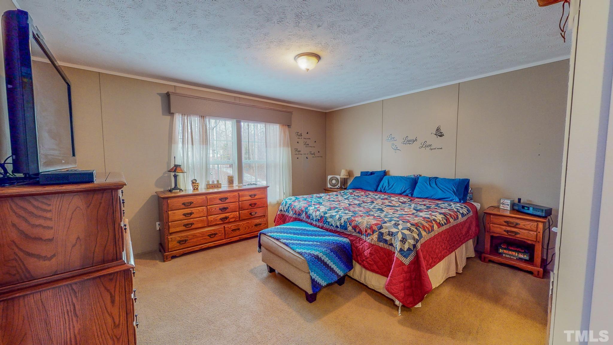 100 Marco Road Roxboro, NC 27574 - Photo 15 of 47 a bedroom with a bed and window
