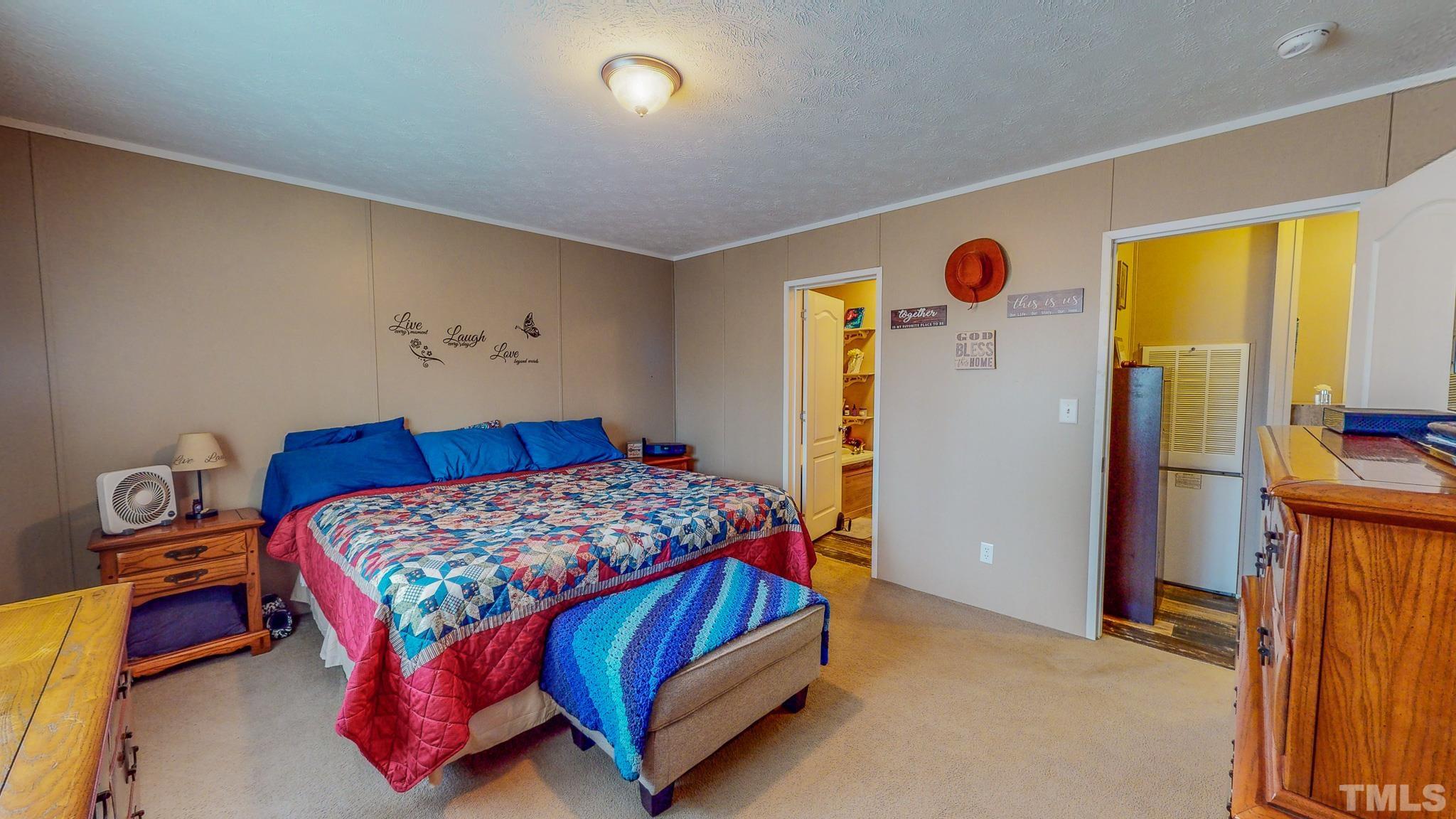 100 Marco Road Roxboro, NC 27574 - Photo 16 of 47 a bedroom with a bed and a refrigerator