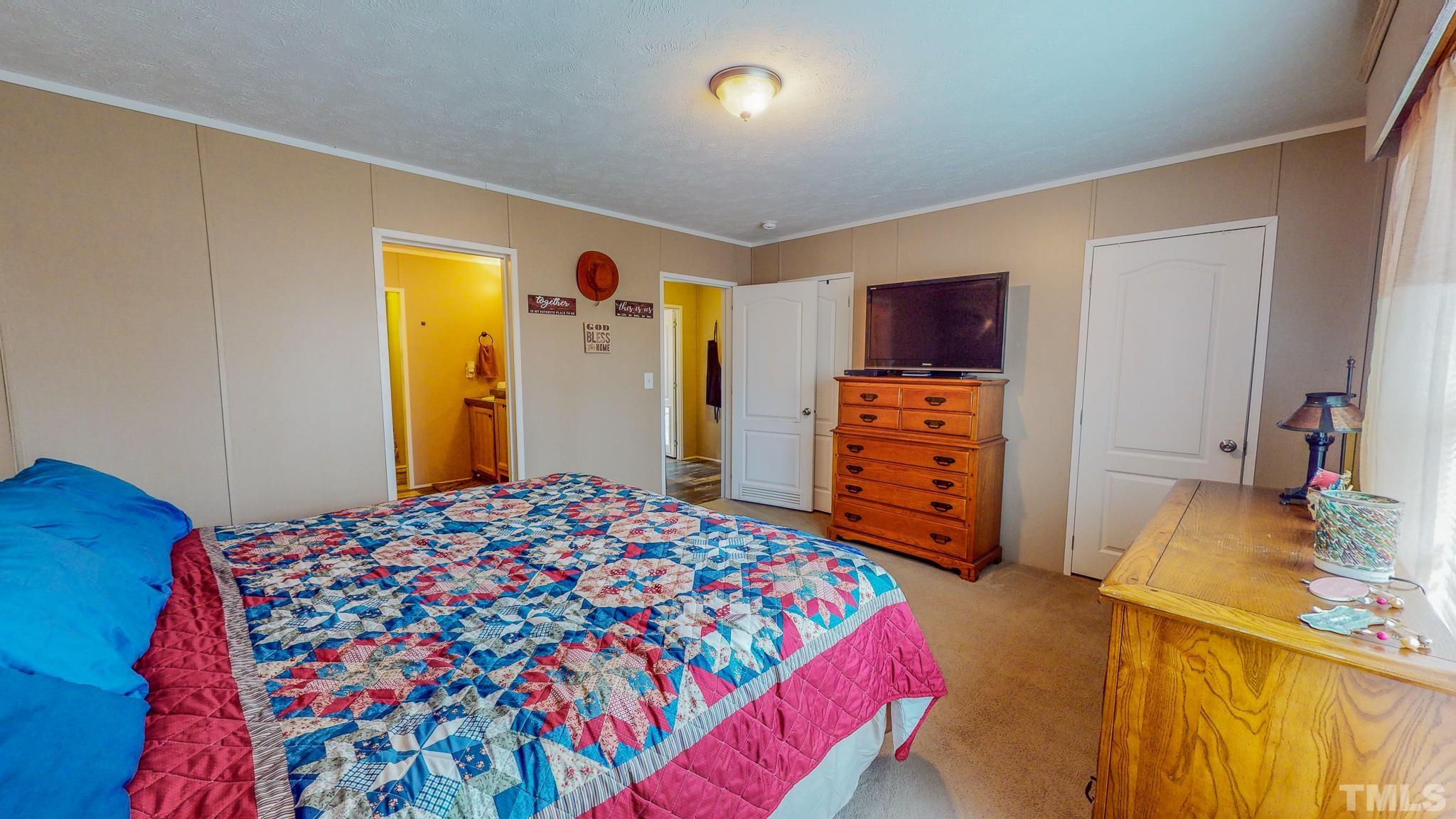 100 Marco Road Roxboro, NC 27574 - Photo 17 of 47 a bedroom with a bed and wooden floor