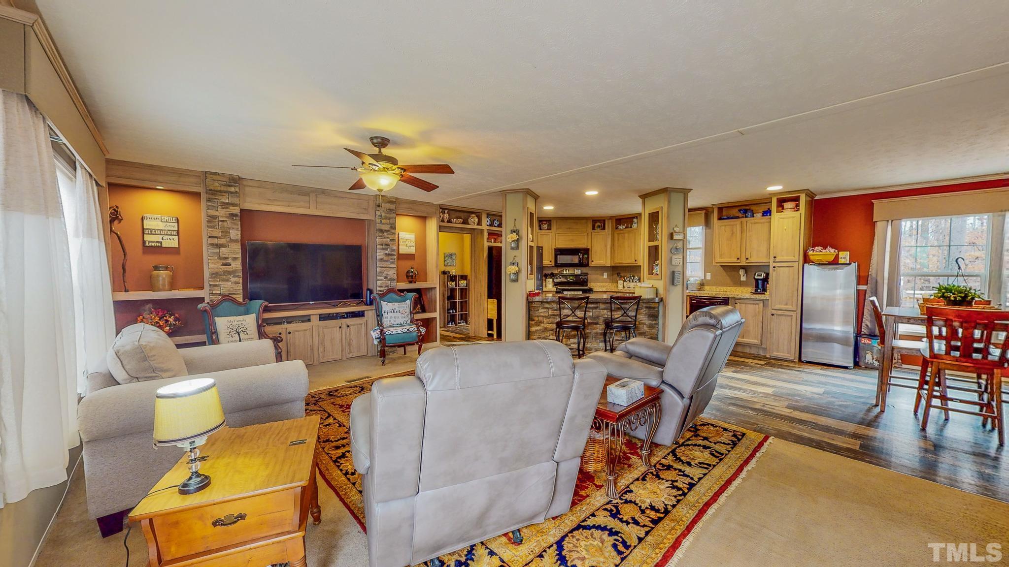 100 Marco Road Roxboro, NC 27574 - Photo 2 of 47 a living room with furniture and a flat screen tv
