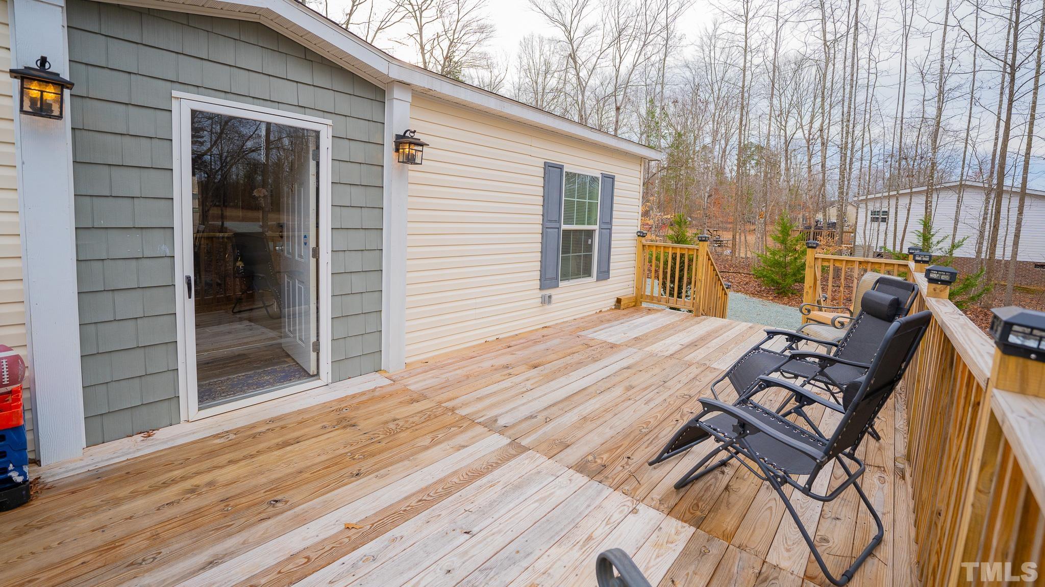 100 Marco Road Roxboro, NC 27574 - Photo 22 of 47 a view of a patio with table and chairs with wooden floor and fence
