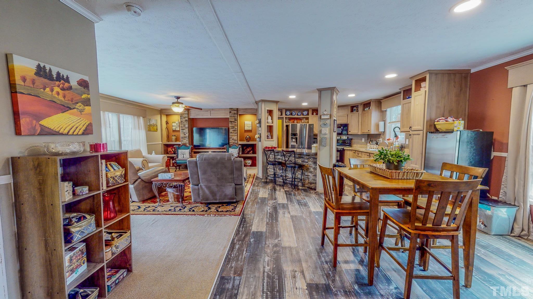 100 Marco Road Roxboro, NC 27574 - Photo 23 of 47 a view of a dining room with furniture and wooden floor