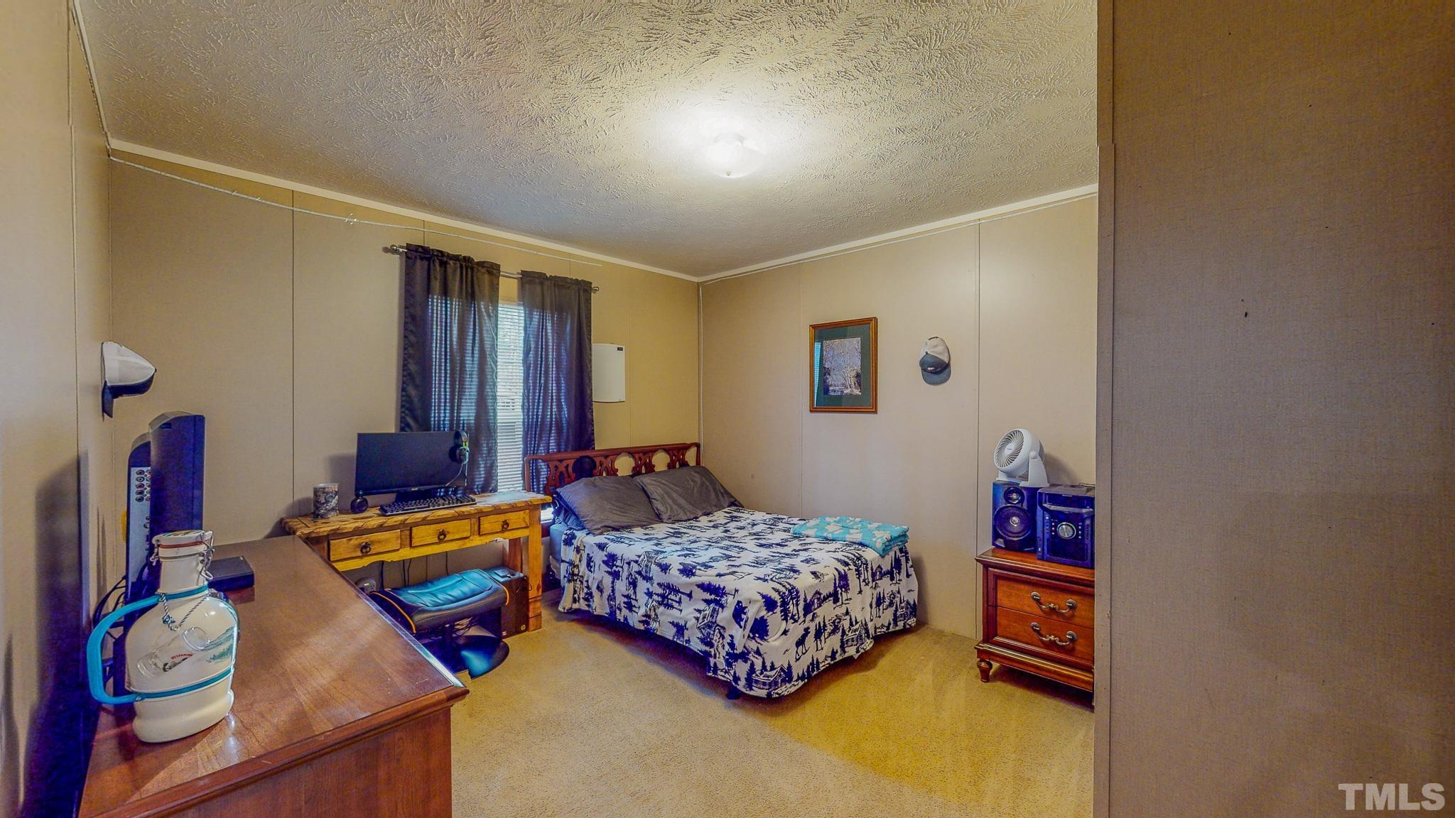 100 Marco Road Roxboro, NC 27574 - Photo 25 of 47 a bedroom with bed and a window