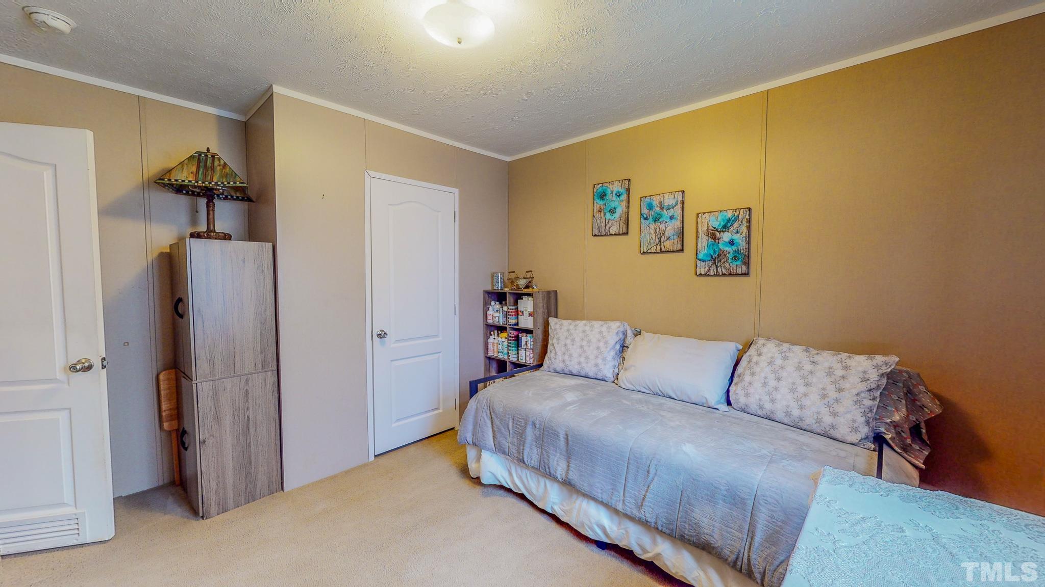 100 Marco Road Roxboro, NC 27574 - Photo 27 of 47 a bedroom with a bed and a couch