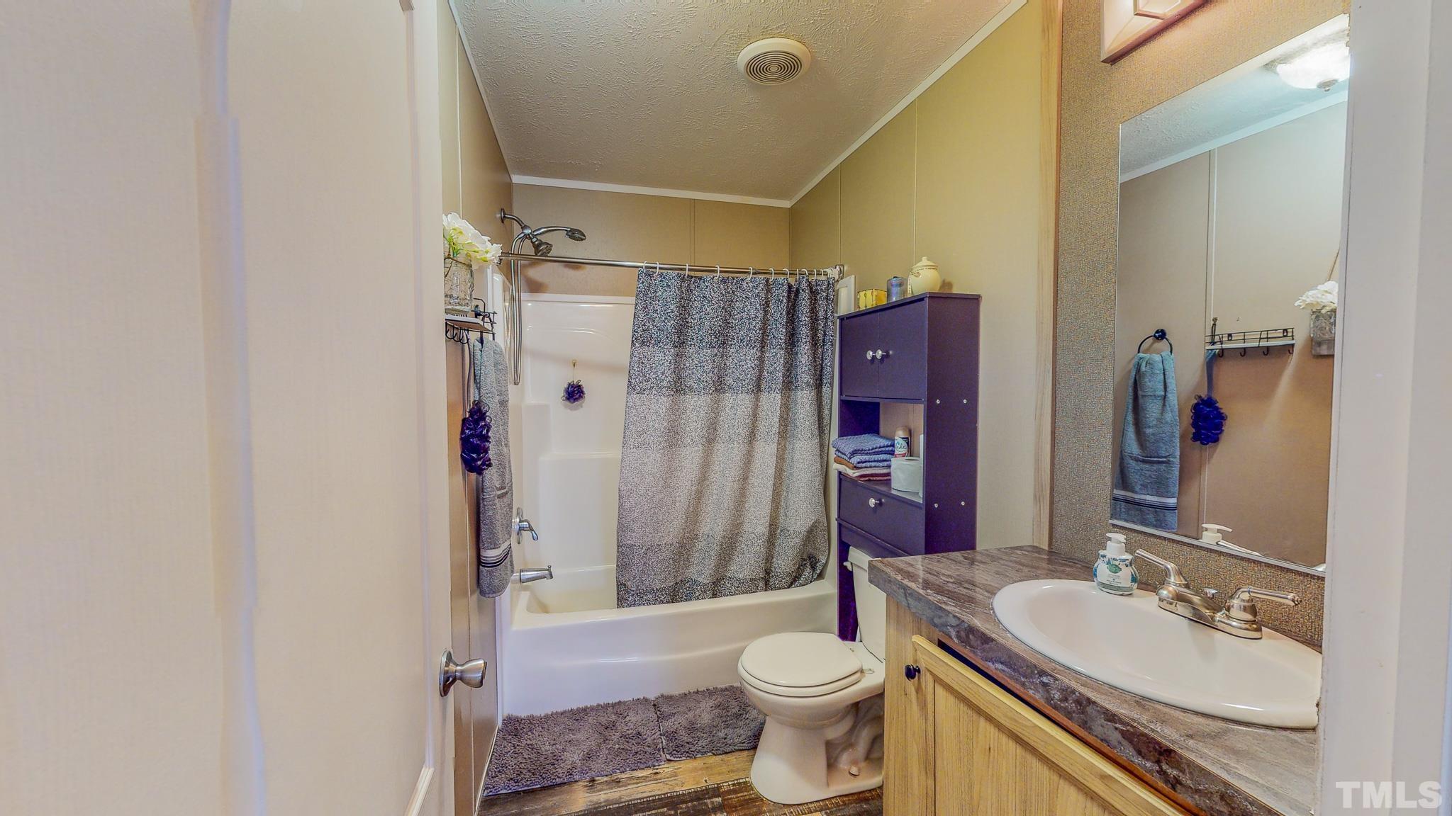100 Marco Road Roxboro, NC 27574 - Photo 28 of 47 a bathroom with a sink toilet tub and shower
