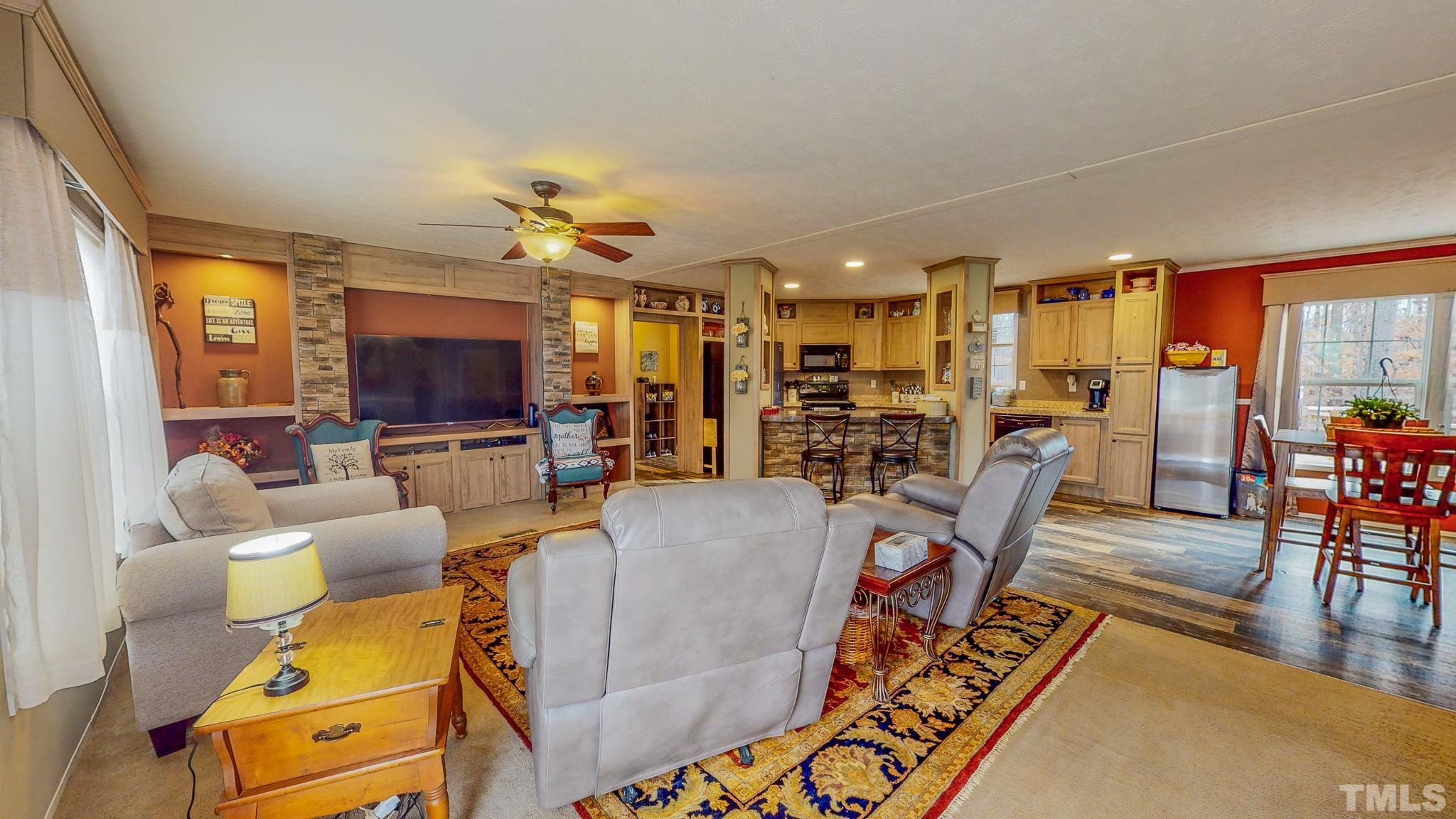 100 Marco Road Roxboro, NC 27574 - Photo 30 of 47 a living room with furniture and a flat screen tv