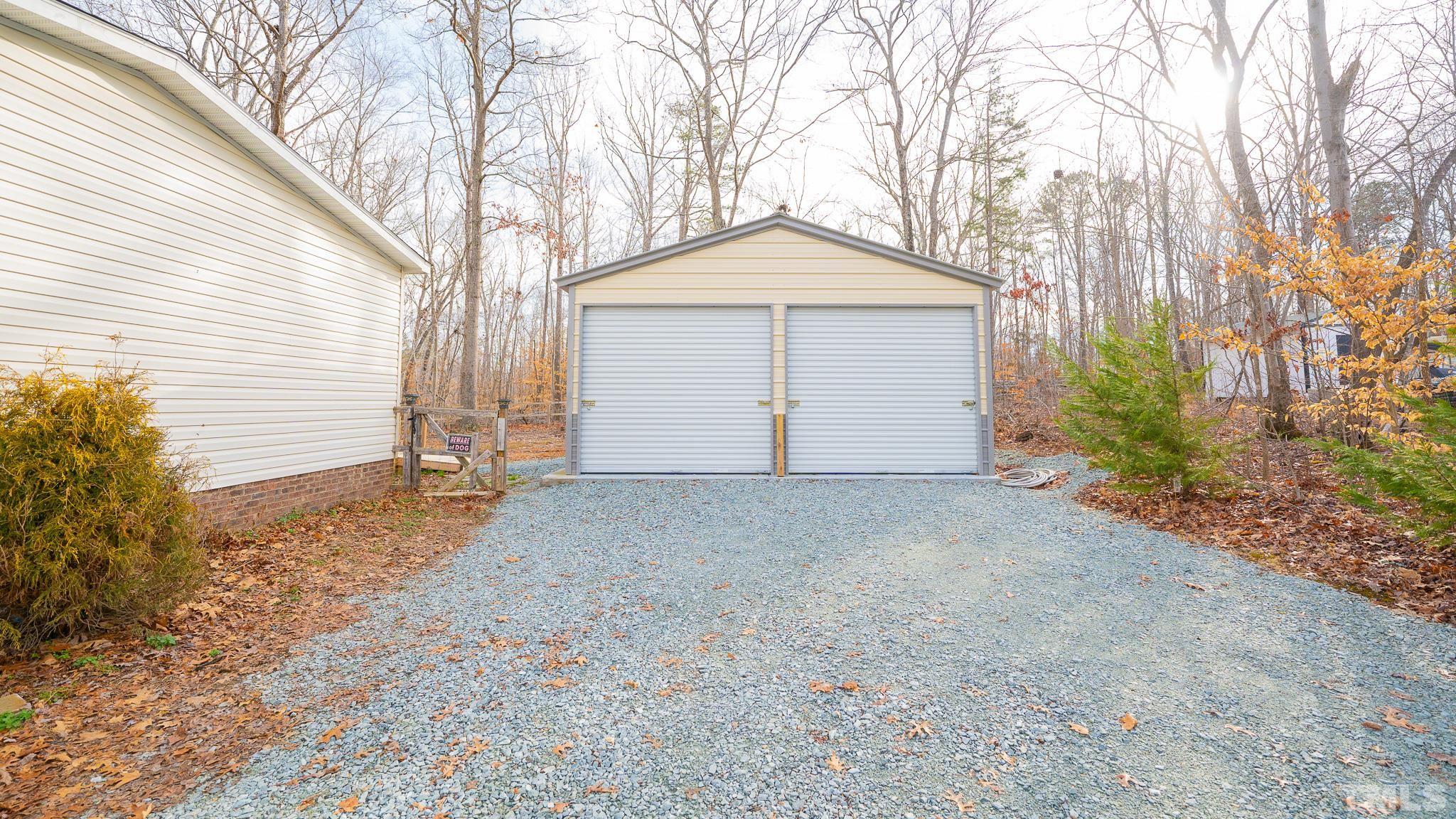 100 Marco Road Roxboro, NC 27574 - Photo 36 of 47 a view of a house with a yard and garage