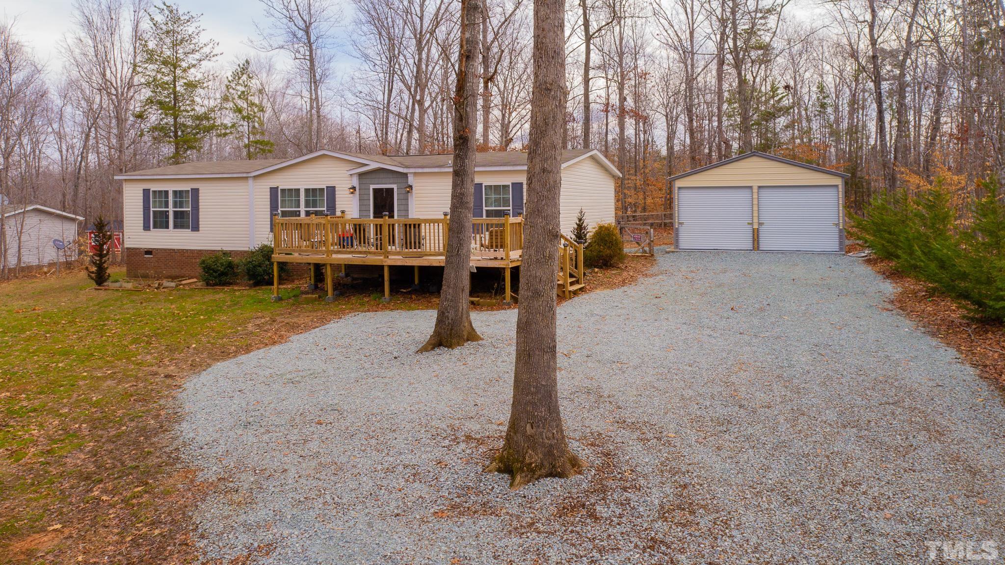 100 Marco Road Roxboro, NC 27574 - Photo 41 of 47 a front view of a house with a yard and garage