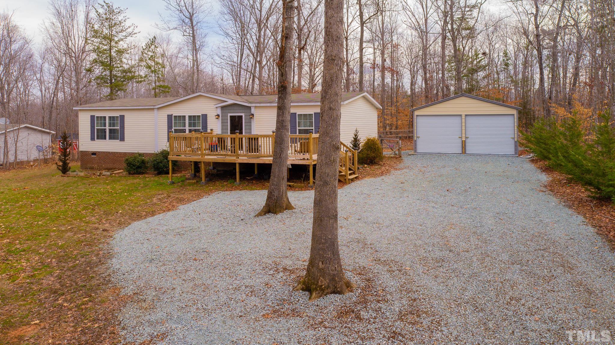 100 Marco Road Roxboro, NC 27574 - Photo 42 of 47 a front view of a house with a yard and garage