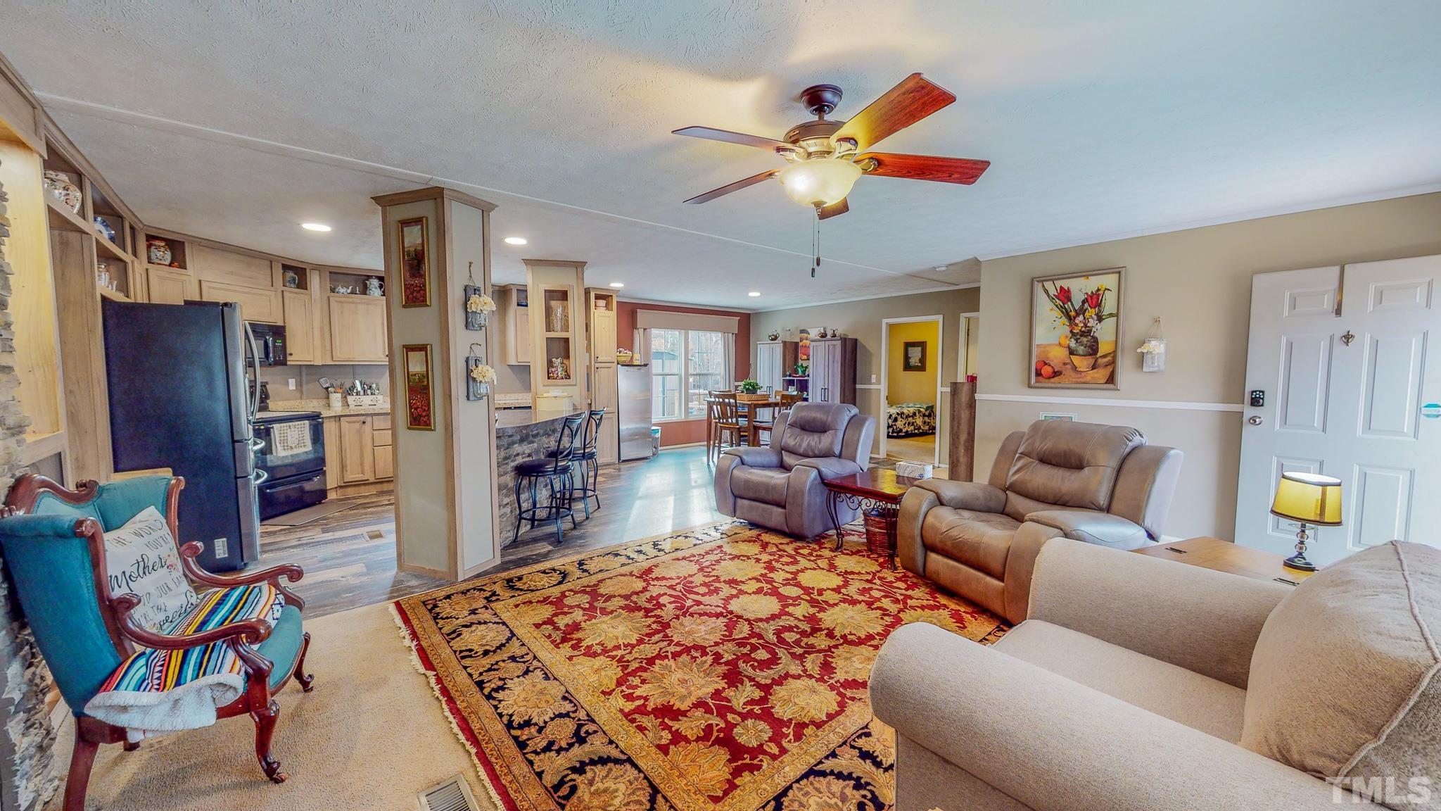 100 Marco Road Roxboro, NC 27574 - Photo 5 of 47 a living room with furniture ceiling fan and a rug