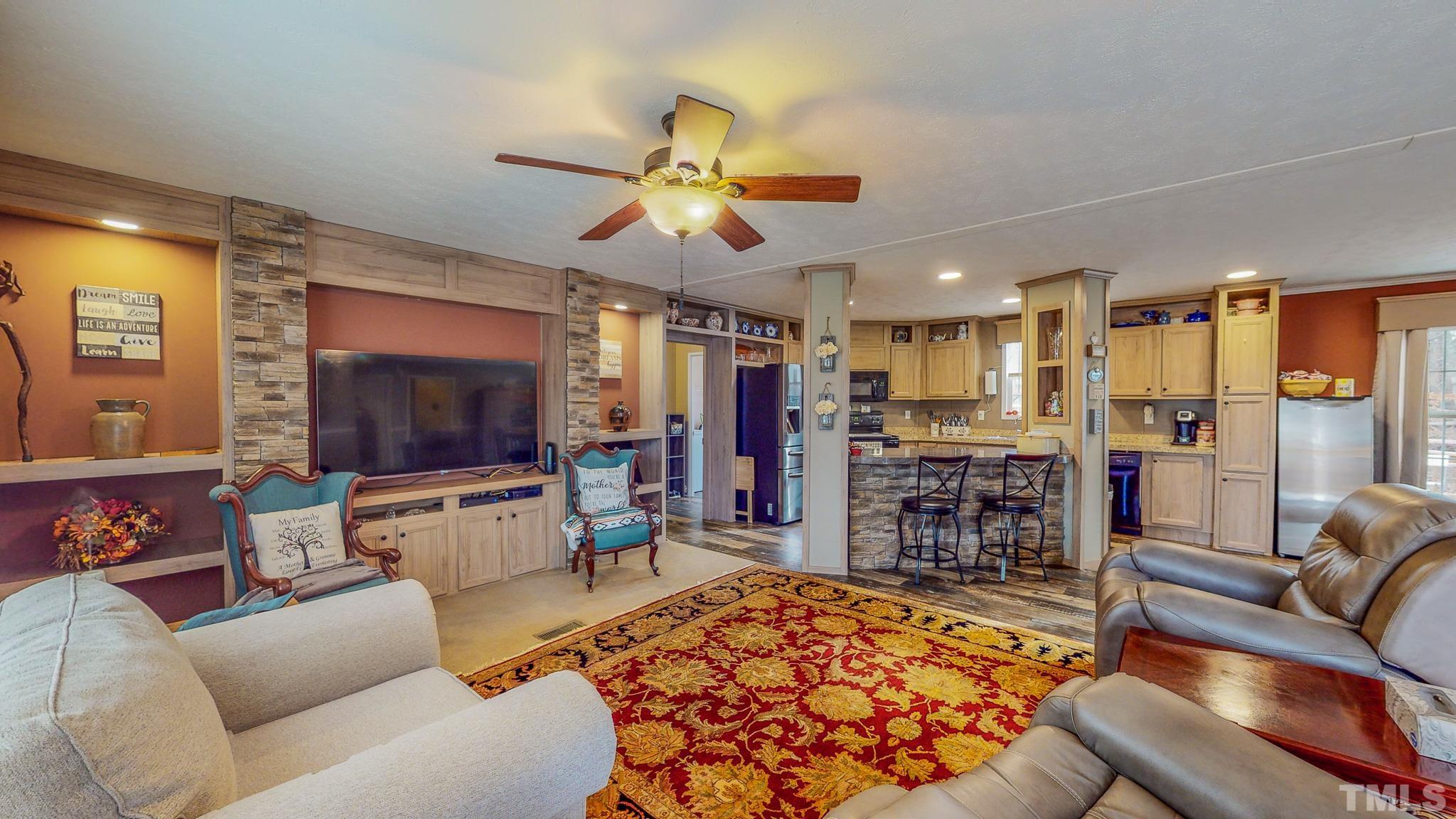 100 Marco Road Roxboro, NC 27574 - Photo 9 of 47 a living room with furniture and a flat screen tv