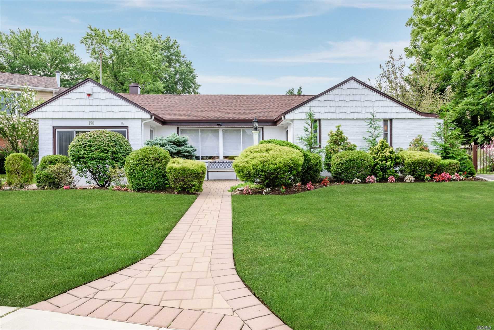 190 Surrey Commons Lynbrook, NY 11563 - Photo 1 of 1 a front view of a house with a yard