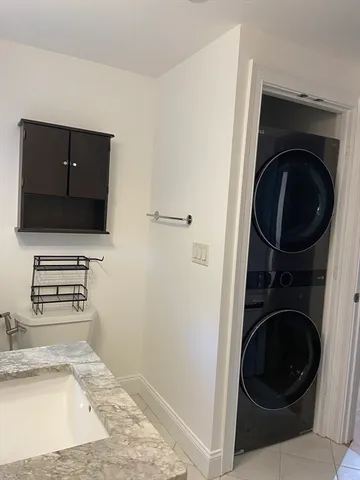 a view of a kitchen with a sink washer and dryer