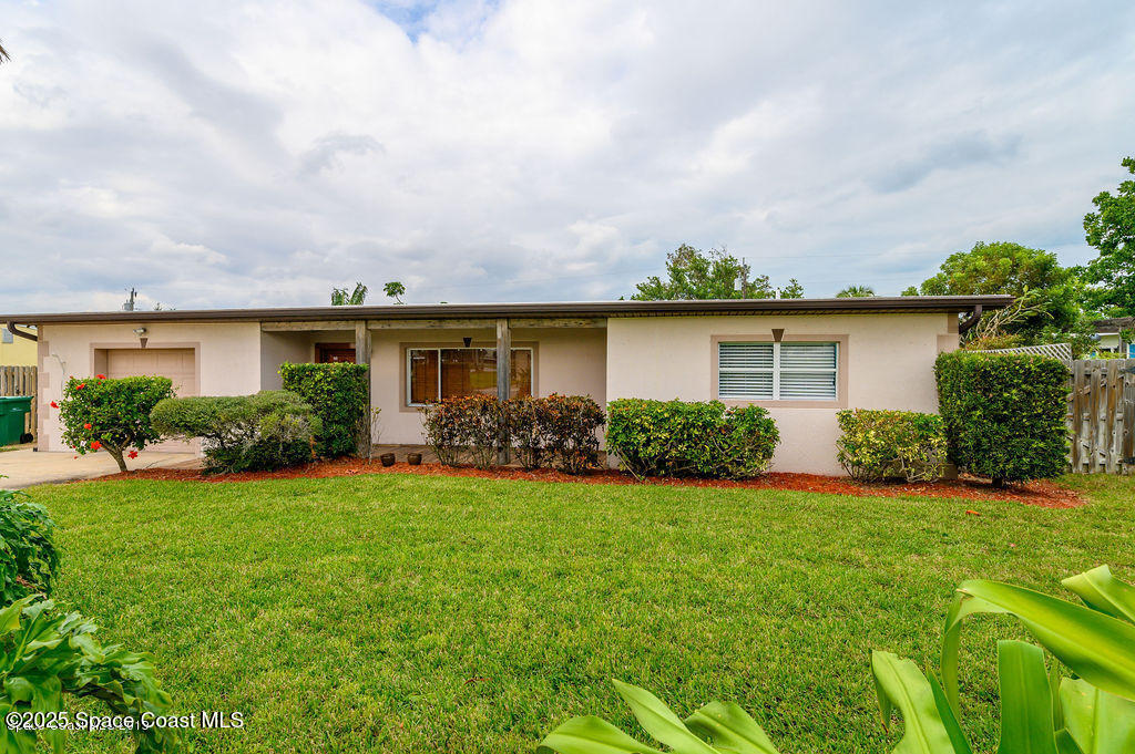 320 Pine Tree Drive Indialantic, FL 32903 - Photo 1 of 13 a view of a house with garden and a sitting area