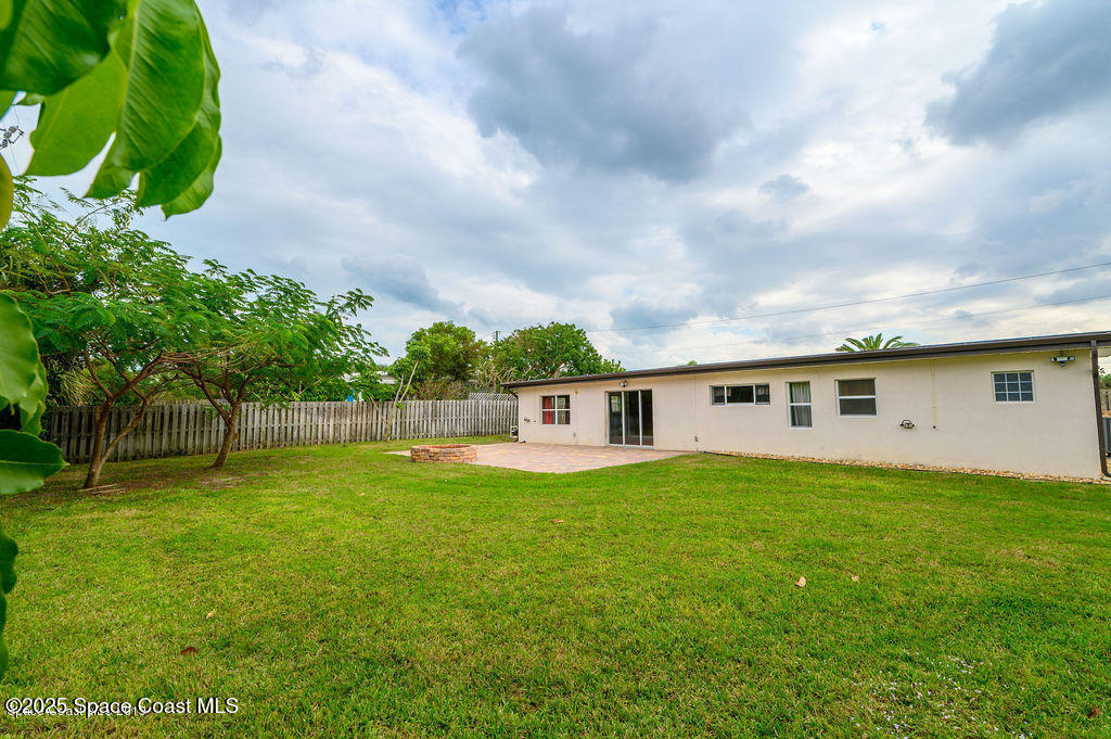 320 Pine Tree Drive Indialantic, FL 32903 - Photo 12 of 13 a backyard of a house with lots of green space