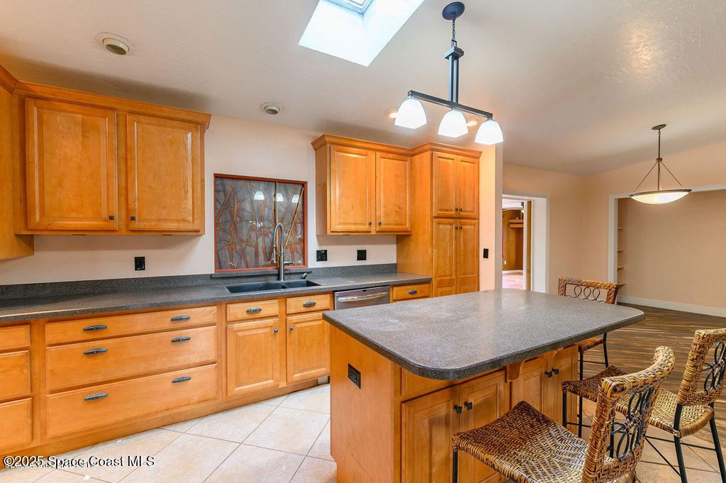 320 Pine Tree Drive Indialantic, FL 32903 - Photo 3 of 13 a kitchen with a table chairs refrigerator and cabinets