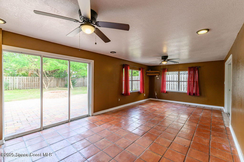 320 Pine Tree Drive Indialantic, FL 32903 - Photo 7 of 13 a view of an empty room with window and chandelier fan
