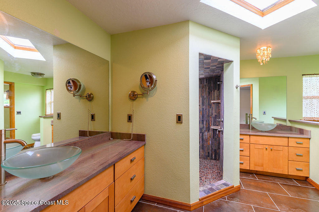 320 Pine Tree Drive Indialantic, FL 32903 - Photo 8 of 13 a bathroom with a granite countertop sink and a mirror