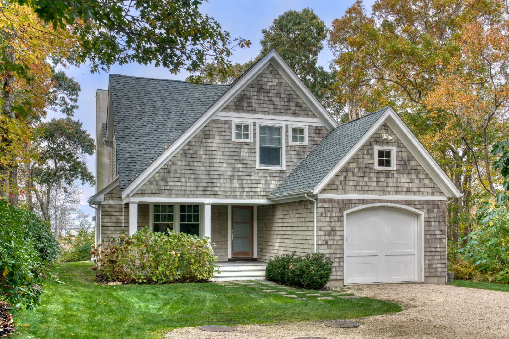 a front view of a house with a garden and plants