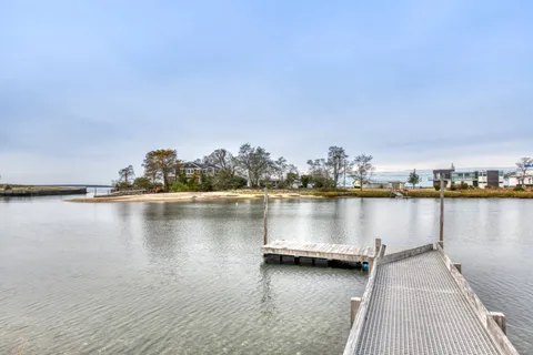 a view of a ocean with boats and trees in the background