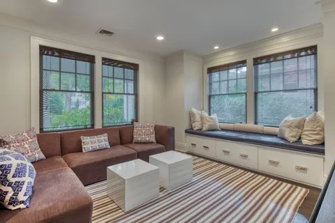 a living room with furniture and large windows