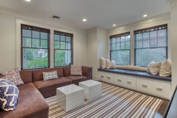 a living room with furniture and large windows