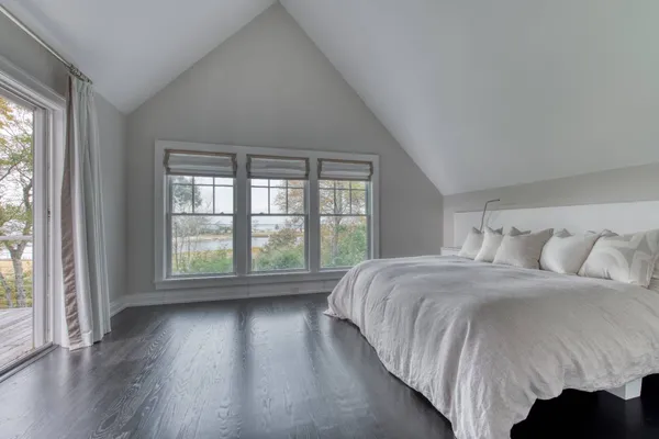 a bed sitting in a bedroom next to a large window