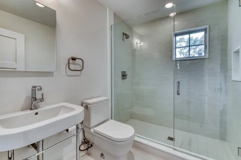a bathroom with a sink toilet and shower