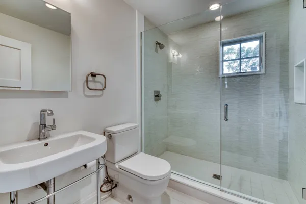 a bathroom with a sink toilet and shower