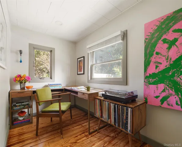 a bedroom with a bed and a potted plant