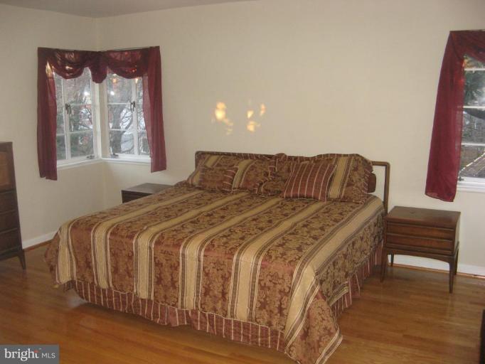 2007 Cascade Road Silver Spring, MD 20902 - Photo 11 of 12 a bedroom with a bed and wooden floor