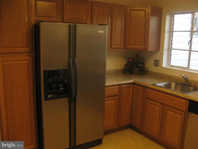 2007 Cascade Road Silver Spring, MD 20902 - Photo 6 of 12 a kitchen with a refrigerator and cabinets
