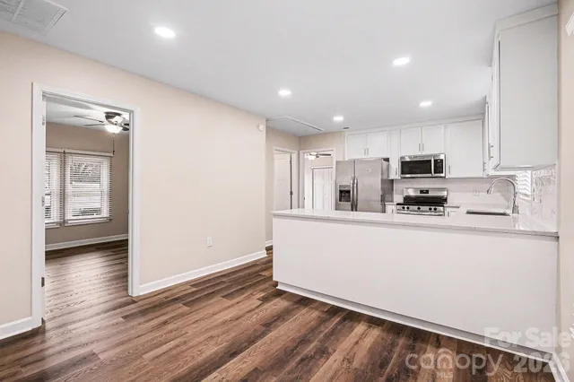 a kitchen with stainless steel appliances granite countertop a refrigerator sink and cabinets