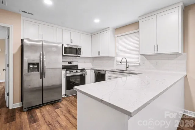 a kitchen with a refrigerator sink and microwave