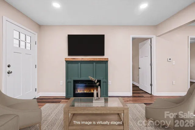 a living room with a fireplace and a rug