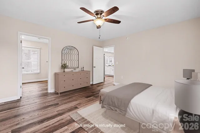 a spacious bedroom with a bed and a chandelier